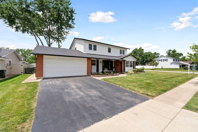 1100 Leicester Rd, Elk Grove Village, IL 60007 - view of front of home with brick siding, an attached garage, driveway, and covered porch
