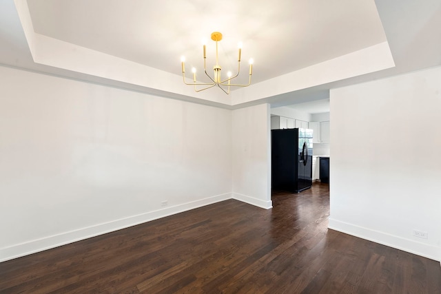 1100 Leicester Rd, Elk Grove Village, IL 60007 - empty room featuring a chandelier, dark wood-style floors, and a raised ceiling