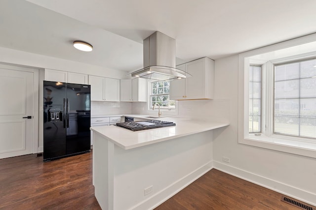 1100 Leicester Rd, Elk Grove Village, IL 60007 - kitchen with black refrigerator with ice dispenser, island range hood, dark wood-style floors, and stainless steel gas cooktop