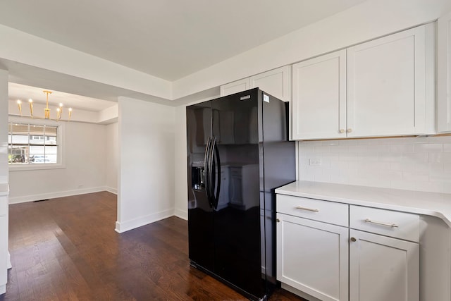 1100 Leicester Rd, Elk Grove Village, IL 60007 - kitchen featuring black fridge with ice dispenser, light countertops, backsplash, dark wood-type flooring, and white cabinetry