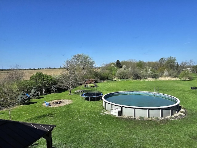 view of community featuring a yard and a swimming pool