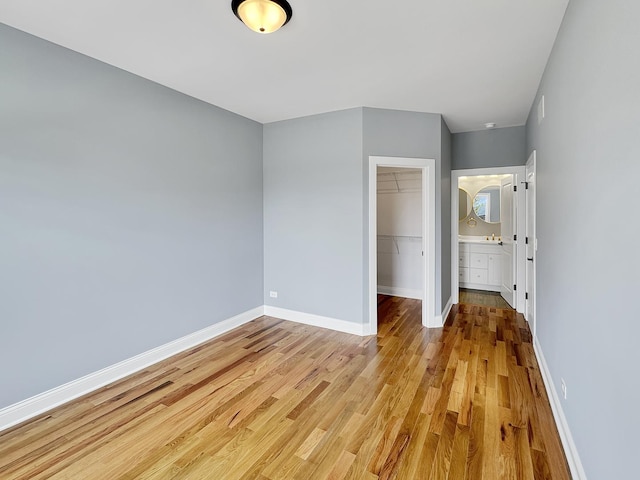 946 Partridge Cir, Marengo, IL 60152 - unfurnished bedroom with baseboards, a closet, wood finished floors, and a spacious closet