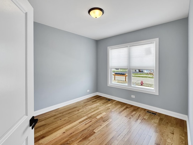 946 Partridge Cir, Marengo, IL 60152 - unfurnished room featuring baseboards, light wood finished floors, and visible vents