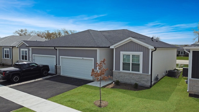 946 Partridge Cir, Marengo, IL 60152 - view of front of house with a garage, aphalt driveway, a front yard, and stone siding