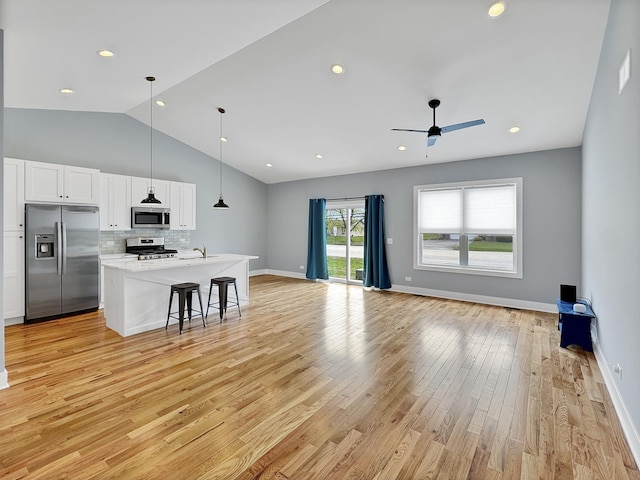 946 Partridge Cir, Marengo, IL 60152 - living area featuring a ceiling fan, vaulted ceiling, baseboards, light wood finished floors, and recessed lighting