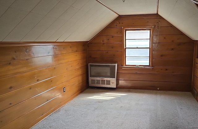 bonus room featuring carpet, wood walls, and lofted ceiling