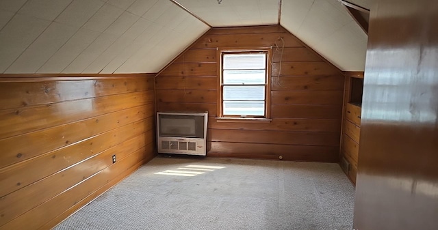 additional living space with wood walls, vaulted ceiling, and carpet floors