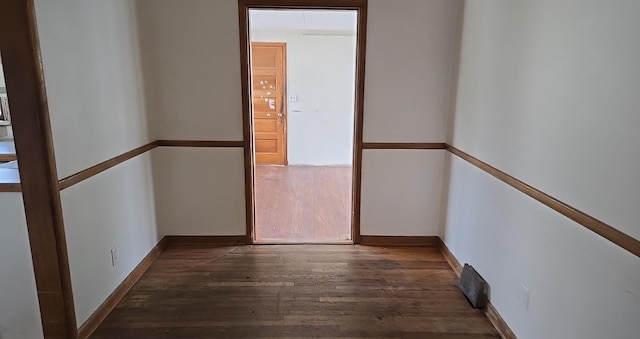 spare room featuring visible vents and wood finished floors