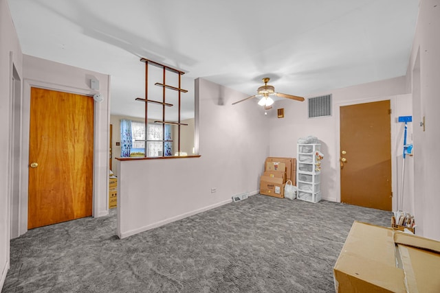 carpeted spare room featuring baseboards, ceiling fan, and visible vents