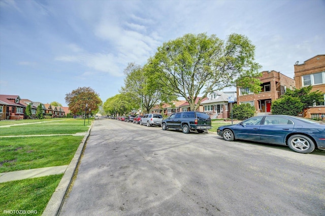 view of street with a residential view and curbs