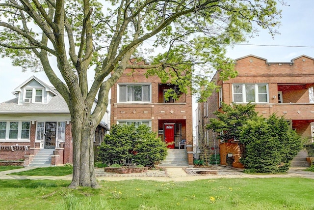 view of front of home with a front yard and brick siding