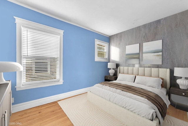 bedroom with light wood-style floors and baseboards