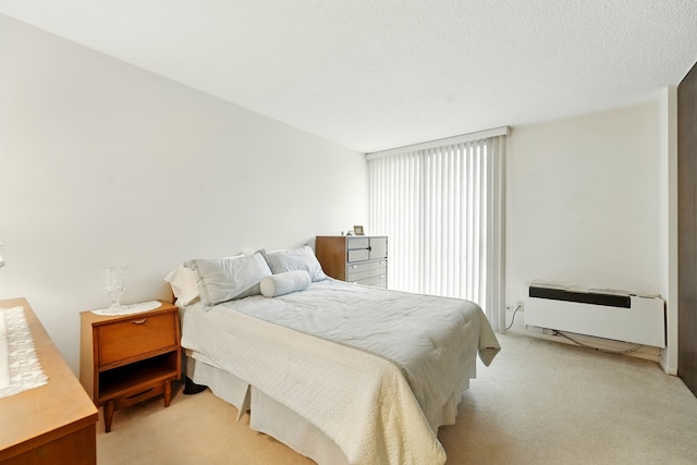 bedroom featuring light colored carpet and heating unit