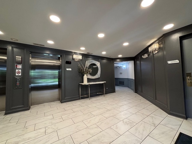 community lobby with a decorative wall and recessed lighting