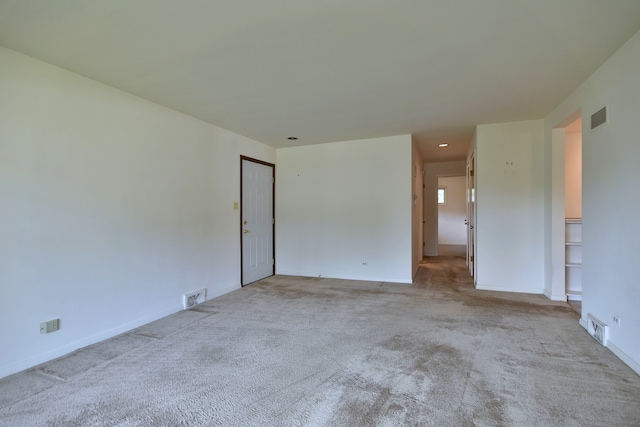 unfurnished room featuring carpet flooring, baseboards, and visible vents