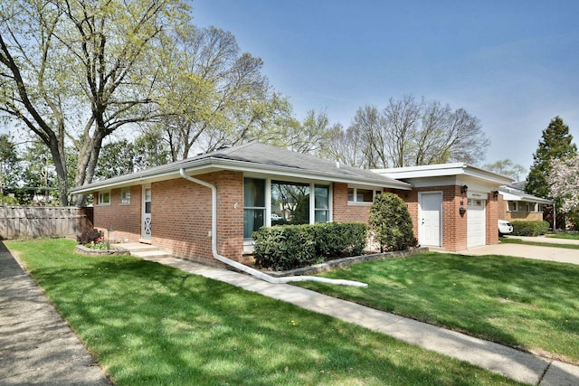 ranch-style house featuring a garage, fence, a front yard, brick siding, and driveway