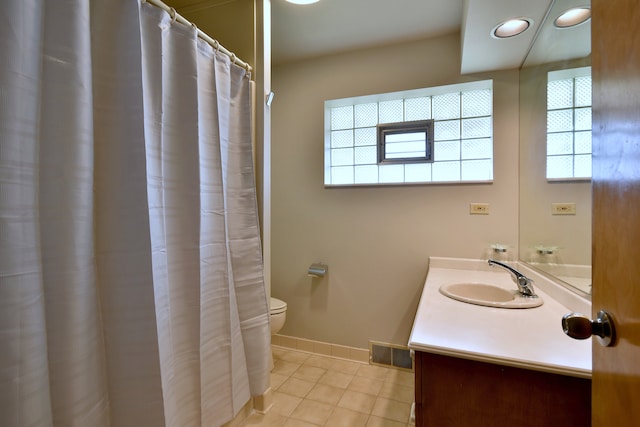 bathroom with visible vents, tile patterned flooring, vanity, toilet, and baseboards