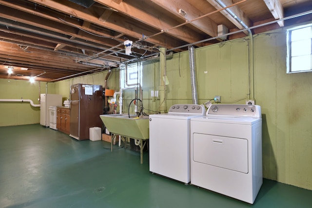 washroom featuring laundry area, a sink, and washer and dryer