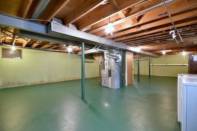 unfinished below grade area with heating unit and washer / dryer