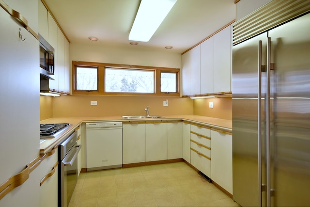 kitchen featuring light countertops, recessed lighting, appliances with stainless steel finishes, and a sink