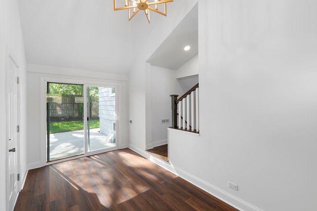 9048 Oneill Dr, Burr Ridge, IL 60527 - unfurnished living room featuring vaulted ceiling, wood finished floors, stairway, baseboards, and a notable chandelier
