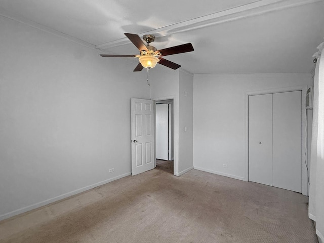 unfurnished bedroom featuring a closet, baseboards, carpet, and a ceiling fan