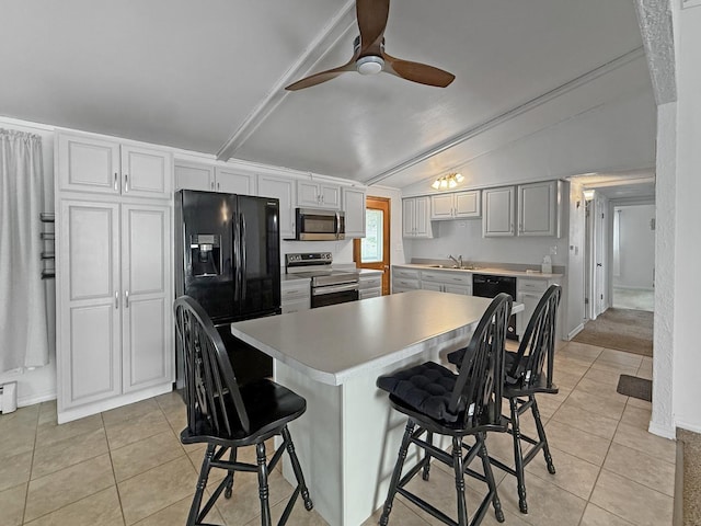 kitchen featuring light countertops, light tile patterned flooring, appliances with stainless steel finishes, and a sink