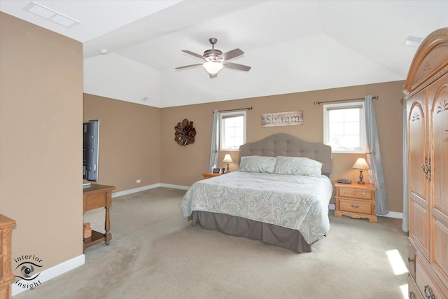 bedroom with baseboards, visible vents, light carpet, and lofted ceiling