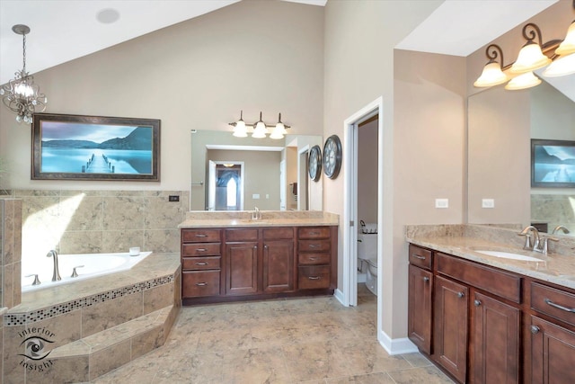 full bathroom with toilet, a sink, lofted ceiling, and a garden tub