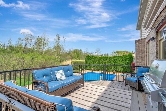 deck with an outdoor living space and area for grilling