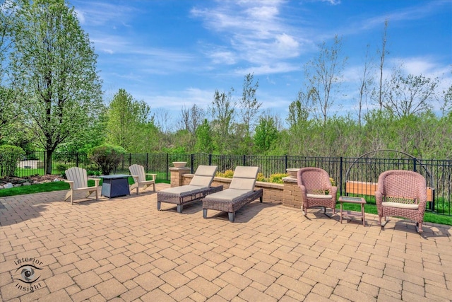 view of patio with fence and an outdoor fire pit