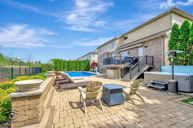 view of swimming pool featuring a patio, a hot tub, a deck, and a fenced in pool