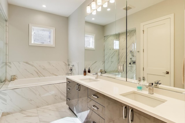 full bath with double vanity, a marble finish shower, a sink, and a garden tub
