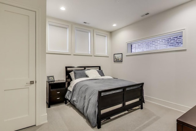 bedroom featuring recessed lighting, light colored carpet, and visible vents