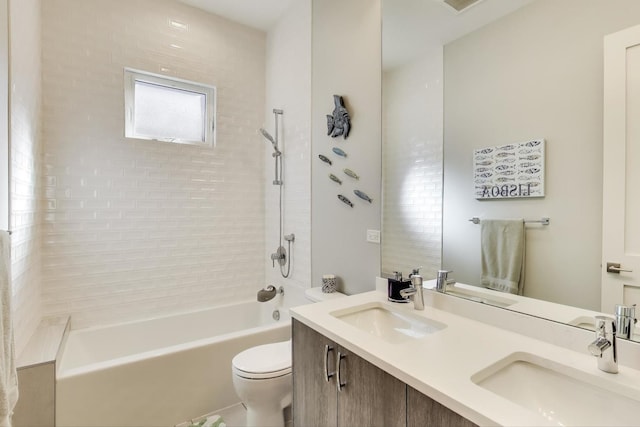 full bathroom featuring double vanity, toilet, bathing tub / shower combination, and a sink