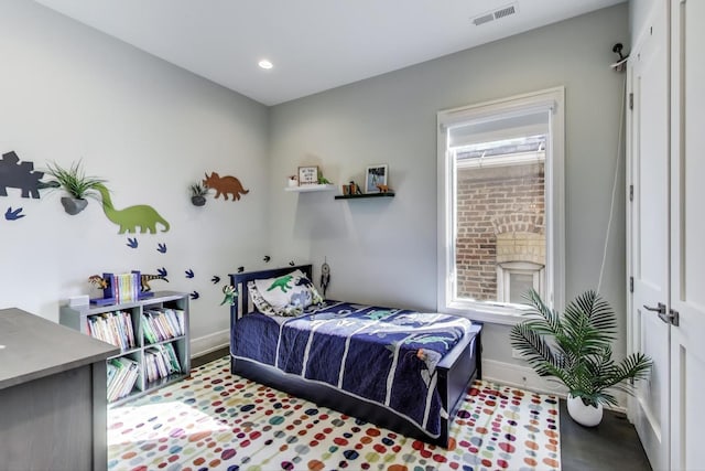 bedroom with baseboards, recessed lighting, and visible vents