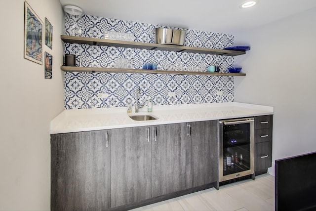 bar featuring a sink and beverage cooler
