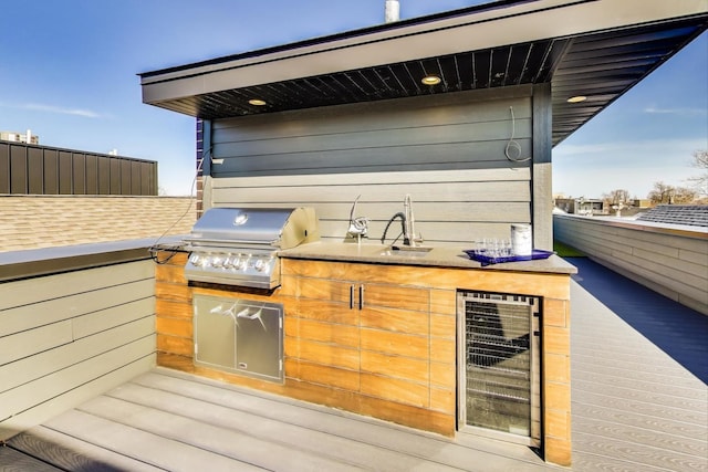 view of patio / terrace featuring beverage cooler, a sink, grilling area, and area for grilling