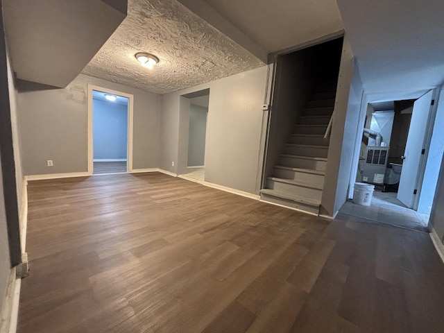 interior space with stairs, wood finished floors, and baseboards