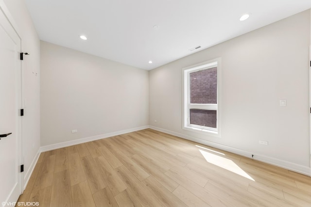 empty room featuring recessed lighting, baseboards, visible vents, and light wood-style floors