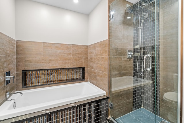 bathroom with recessed lighting, a stall shower, a bath, and tile walls