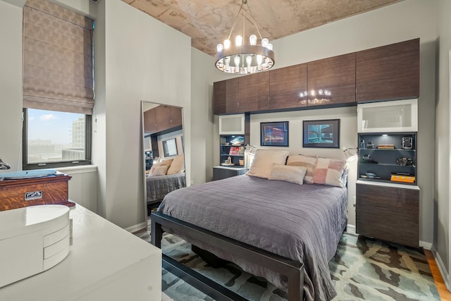bedroom with baseboards and a notable chandelier