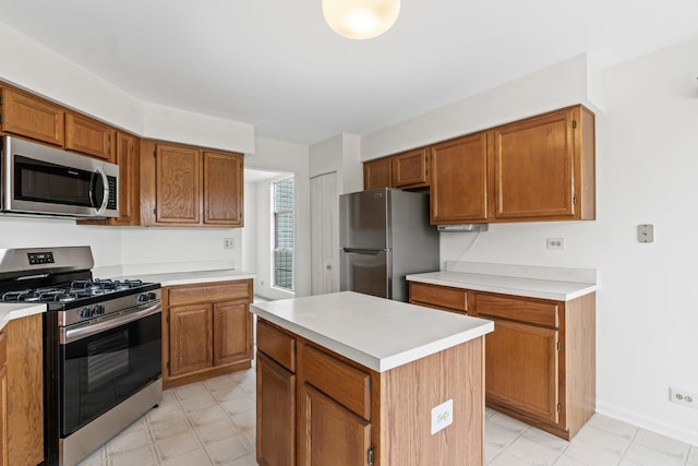 14 Mckinley Ln, Streamwood, IL 60107 - kitchen featuring a kitchen island, baseboards, light countertops, brown cabinets, and stainless steel appliances