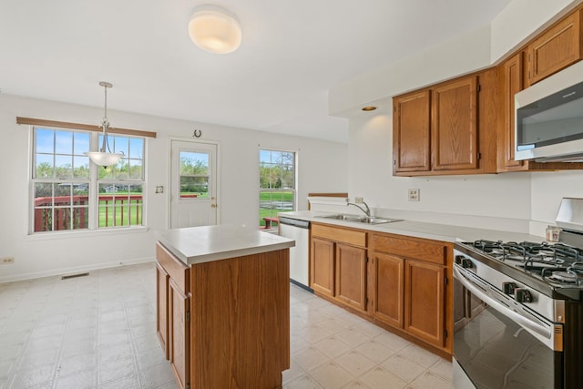 14 Mckinley Ln, Streamwood, IL 60107 - kitchen featuring brown cabinets, a sink, light countertops, stainless steel appliances, and light floors