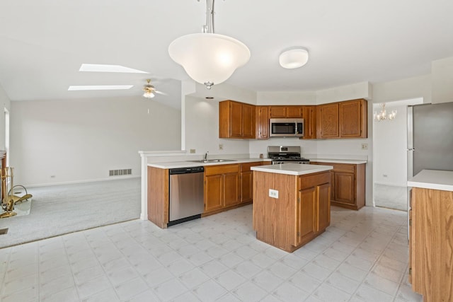 14 Mckinley Ln, Streamwood, IL 60107 - kitchen featuring brown cabinetry, a sink, and appliances with stainless steel finishes