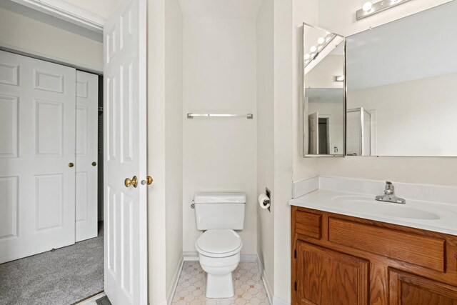 14 Mckinley Ln, Streamwood, IL 60107 - bathroom featuring vanity, baseboards, and toilet
