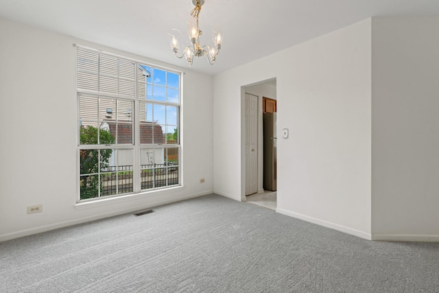 14 Mckinley Ln, Streamwood, IL 60107 - unfurnished room with baseboards, a notable chandelier, light carpet, and visible vents