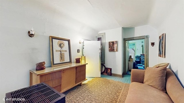 interior space featuring lofted ceiling and light wood-type flooring