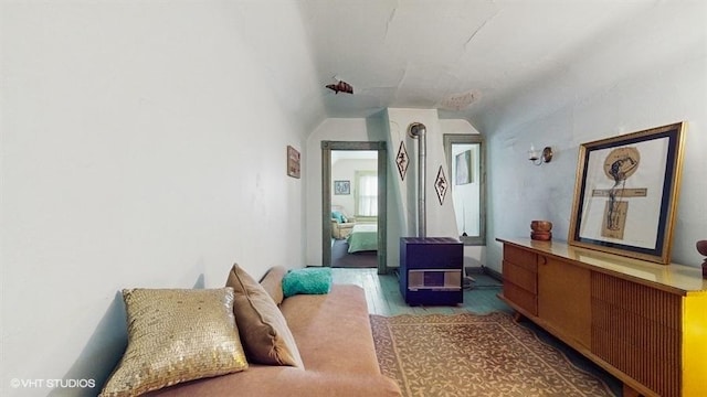 bedroom with wood finished floors and vaulted ceiling