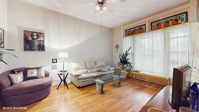 living area featuring a ceiling fan and light wood-style flooring